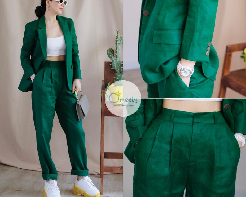May include: A green linen trouser suit with a blazer and matching trousers. The suit is tailored and has a classic style.