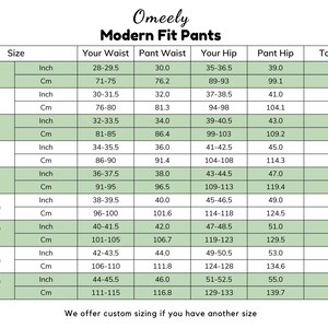 May include: A size chart for Omeely Modern Fit Pants featuring a table with columns for size, waist, hip, and total rise measurements in inches and centimeters. The chart lists sizes from 28 (XS) to 44 (5XL) with specific numerical data.