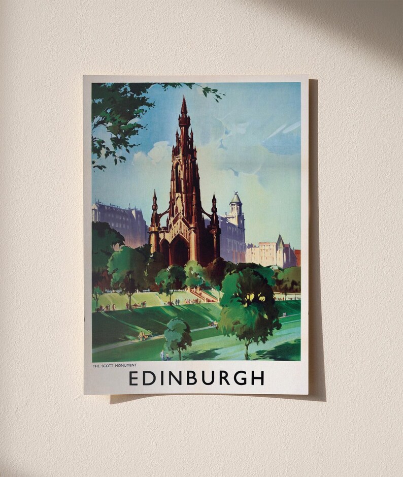 May include: A vintage-style travel poster featuring the Scott Monument in Edinburgh, Scotland. The illustration depicts the dark gothic spire rising above green parkland and trees under a blue sky, with the text THE SCOTT MONUMENT EDINBURGH below.
