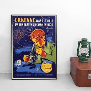 May include: A vintage poster with a blue background and a young person looking through a microscope. The poster reads "ERKENNE was die welt im innersten zusammen halt Goethe" and "STUDIENARBEIT DER FREIEN DEUTSCHEN JUGEND".
