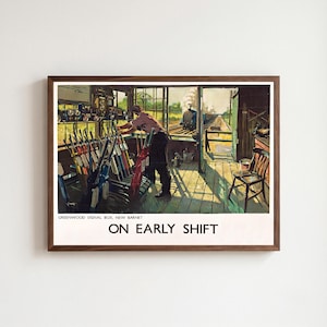 May include: A framed vintage-style poster titled "ON EARLY SHIFT" depicting a signal operator in a Greenwood Signal Box, New Barnet. The scene shows a person operating a row of colorful levers with a steam train visible on tracks outside.