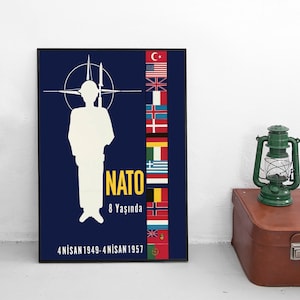 May include: A blue and yellow poster with a white silhouette of a soldier standing in front of a NATO symbol. The poster features the flags of NATO member countries and the text "NATO 8 Yaşında 4 NİSAN 1949-4 NİSAN 1957".