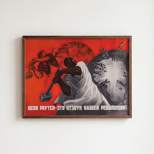 May include: A framed poster featuring a red background with two figures breaking chains with hammers. The artwork depicts a dark grey circular object shattering, with white text at the bottom reading: ЦЕПИ РВУТСЯ-ЭТО ОТЗВУК НАШЕЙ РЕВОЛЮЦИИ!