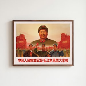 May include: A framed propaganda poster featuring a large portrait of Mao Zedong above a group of soldiers in green uniforms holding red books. The background shows red flags and a city skyline. The text at the bottom reads in red Chinese characters.