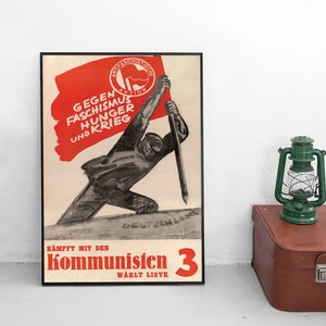 May include: A vintage political poster with a red flag and the text "Gegen Faschismus Hunger und Krieg" (Against Fascism Hunger and War). The poster also features the text "Kampft mit den Kommunisten 3 Wählt Liste" (Fight with the Communists 3 Vote List).