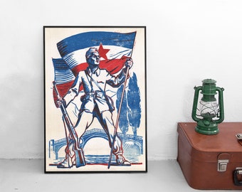 May include: A framed poster print featuring a stylized illustration of a soldier in uniform holding a rifle and a flagpole. The soldier stands before a large flag with a red star, a bridge, and trees, rendered in a bold blue and red color palette.