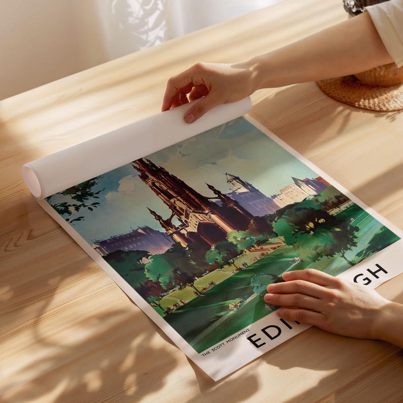 May include: A rectangular art print featuring a stylized illustration of the Scott Monument in Edinburgh, Scotland. The print displays a dark gothic tower surrounded by green trees and a park, with the text THE SCOTT MONUMENT and EDINBURGH visible.