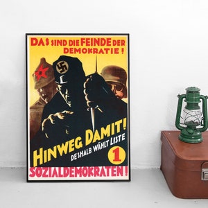 May include: A vintage propaganda poster with a yellow background and black text. The poster depicts three men in military uniforms, one of whom is holding a knife. The text reads "DAS SIND DIE FEINDE DER DEMOKRATIE! HINWEG DAMIT! DESHALB WÄHLT LISTE 1 SOZIALDEMOKRATEN!"
