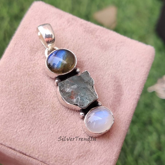 Garnet and moonstone bat pendant with three stones.