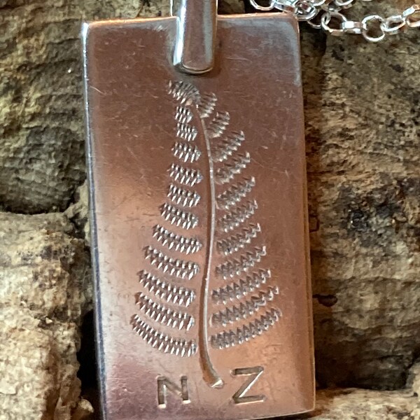 Vintage, silver panel with fern and NZ letters.