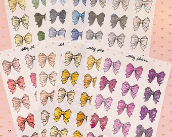 May include: Four sheets of clear sticker paper with holographic glitter. Each sheet has a different color bow design. The bows are in shades of pink, purple, yellow, orange, blue, green, and gray. The text "sky plans" is printed on each sheet.