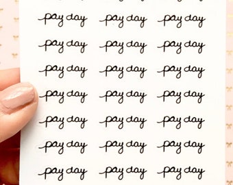 May include: A sheet of white sticker paper with the phrase "Oky plans" written at the top. The sheet is filled with 18 black handwritten stickers that say "pay day".