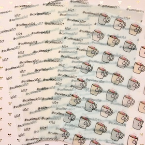 May include: Transparent sticker sheets with coffee cup illustrations, tea bags, and the text "#coffeeaddict" in black. The stickers are set against a light background with small bow patterns.