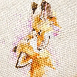 May include: Cross-stitch embroidery depicting two foxes cuddling, with a watercolour-like effect in shades of orange, brown, and pink.