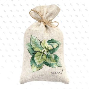 May include: A beige burlap bag tied with twine, featuring a cross-stitched green and white basil plant design. The word "mint" is stitched below the plant. The bag is filled and tied at the top.