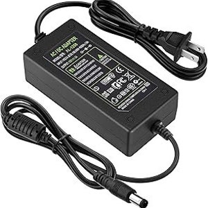May include: Black AC/DC adapter with a US plug and a thin black power cord. The adapter has a label that reads "AC/DC Adapter, Input: 100-240V 50/60Hz 0.5A, Output: 12V 1A".