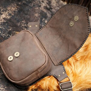 Boho leather waist pouch with gemstone centerpiece and brass stud embellishment.