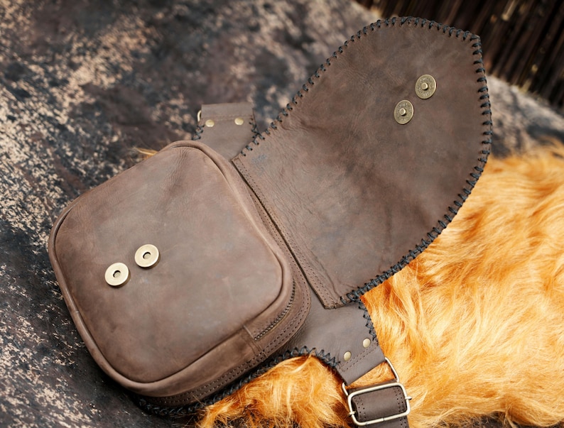 Boho leather waist pouch with gemstone centerpiece and brass stud embellishment.