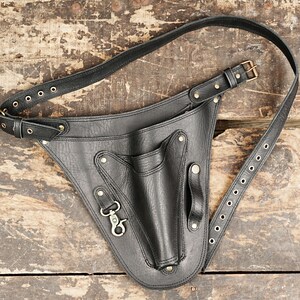 A stylish bag that holds small tools and supplies like rulers and edge bevelers.
