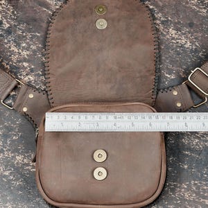 Genuine tan leather hip bag with gemstone accent and rustic handcrafted design.