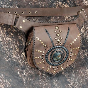 Handmade gemstone leather hip pouch with rustic stitching and brass stud pattern.