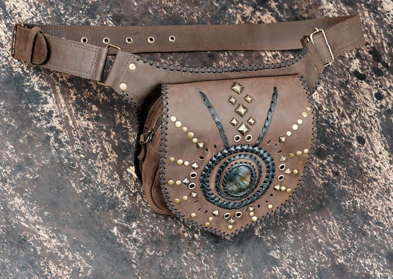 Handmade gemstone leather hip pouch with rustic stitching and brass stud pattern.