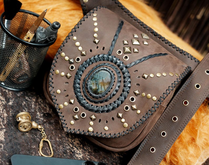 Boho steampunk leather waist bag featuring gemstone centerpiece and decorative stitching.