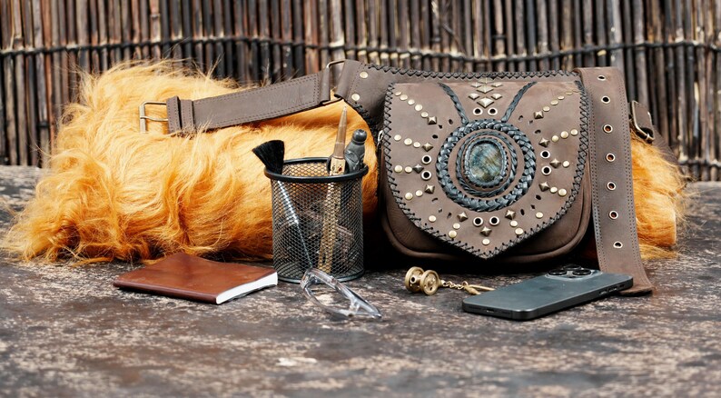 Handmade gemstone belt bag with tan leather, braided edges, and adjustable fit.