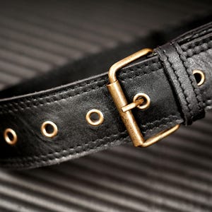 Black leather sling bag and crossbody waist pack with zippered compartments