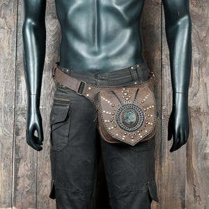 Steampunk leather waist bag made of tan leather with gemstone centerpiece.