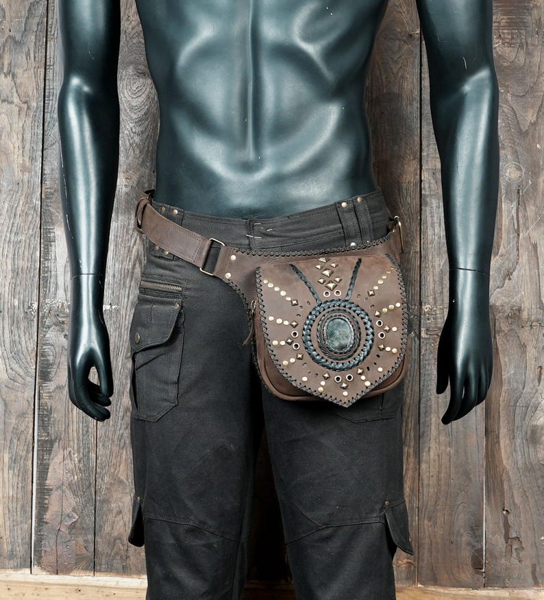 Steampunk leather waist bag made of tan leather with gemstone centerpiece.