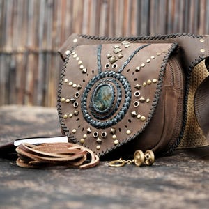 Handmade leather festival belt bag with gemstone centerpiece and brass rivets.