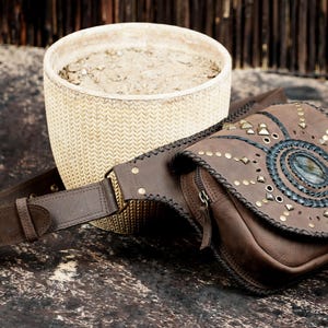 Bohemian leather hip pouch with gemstone centerpiece and unique handcrafted pattern.