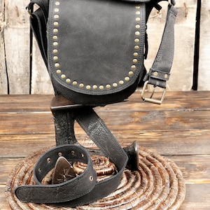 Black leather fanny pack with flap closure and stud decoration