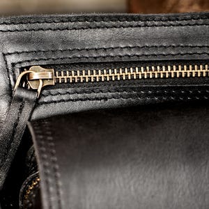 Black full-grain leather utility belt bag for hands-free travel and everyday carry