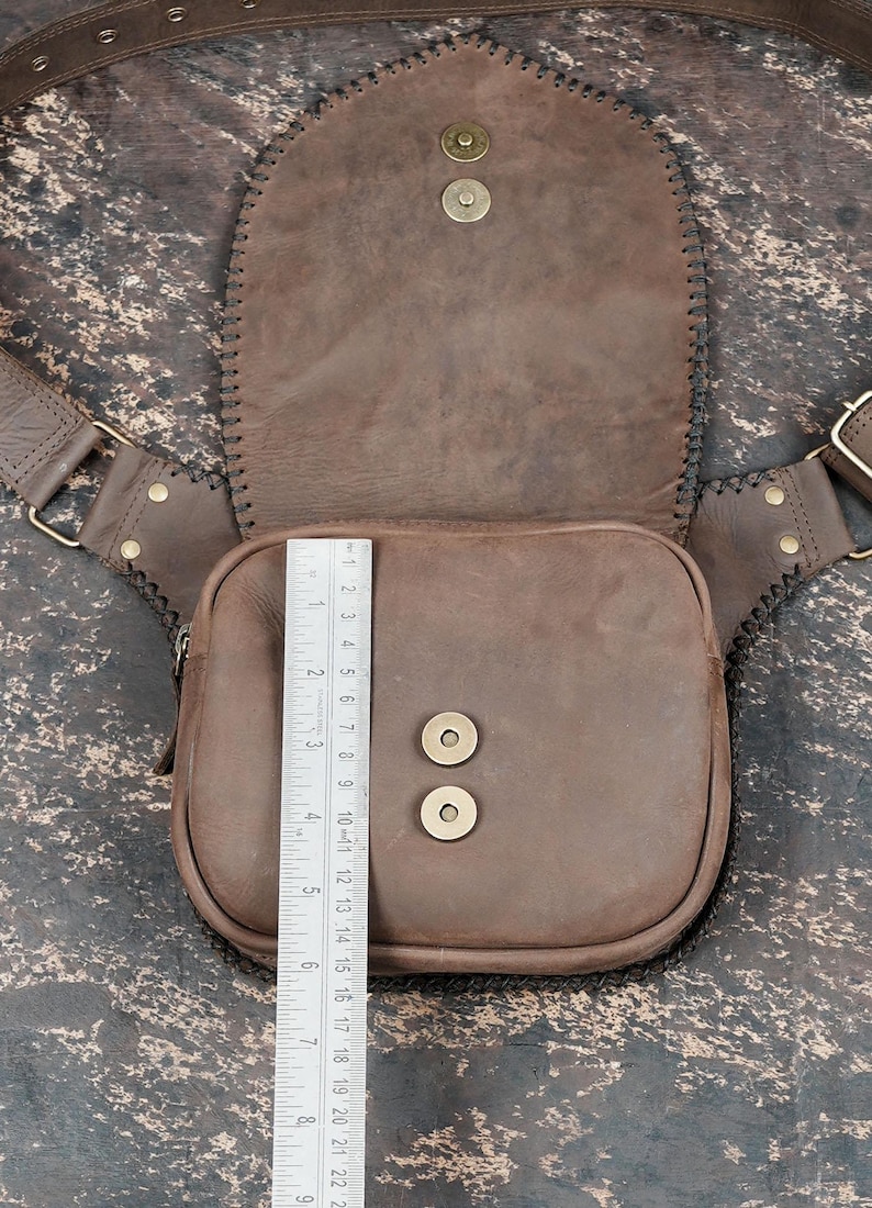 Festival-style gemstone waist bag with tan leather finish and braided black trim.