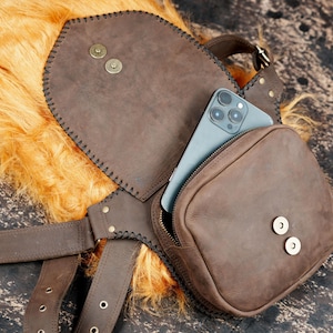Steampunk-inspired leather waist belt bag with gemstone accent and artisan finish.