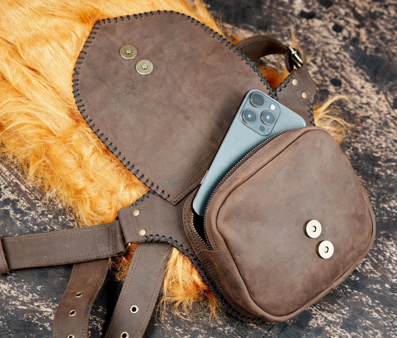 Steampunk-inspired leather waist belt bag with gemstone accent and artisan finish.