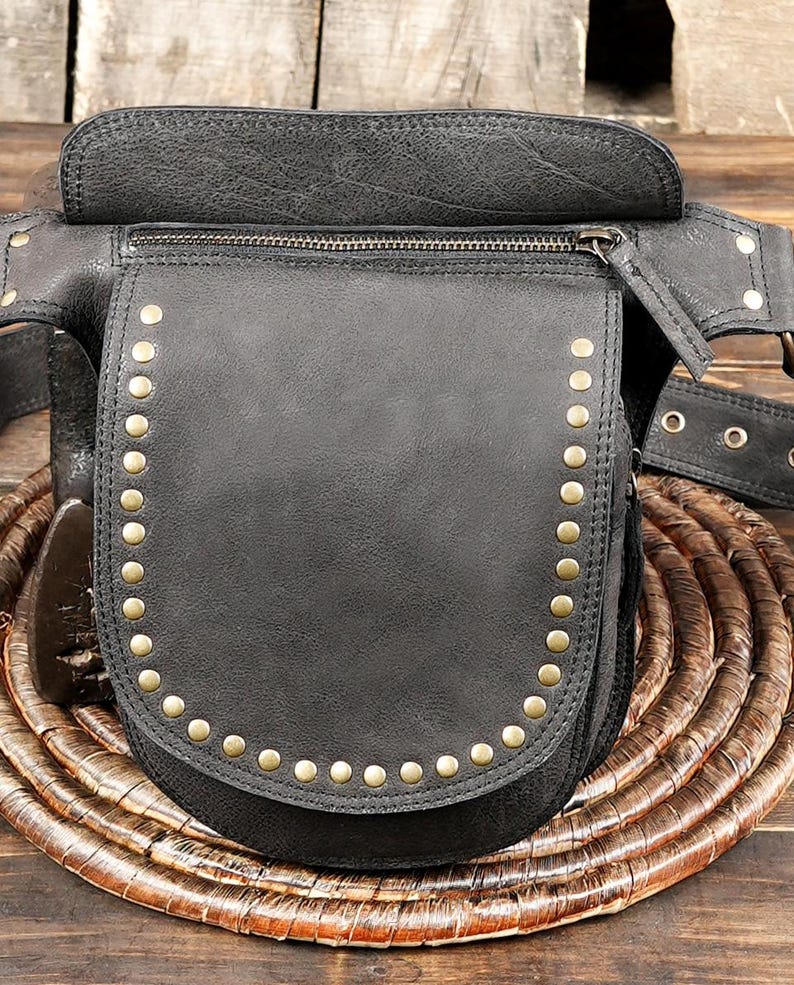 Black leather belt bag with secure flap and metal stud detailing