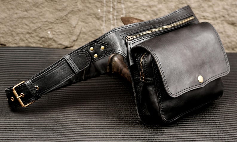 Handcrafted black leather fanny pack with brass hardware and adjustable waist belt