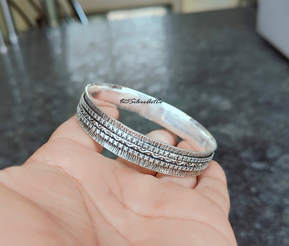 Sterling Silver Spinner Bangle: Handcrafted Textured Cross Design