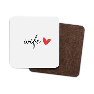 May include: White coaster with the word "wife" written in black cursive script and a red heart.