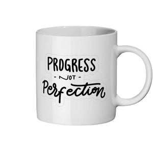 May include: White ceramic mug with black text that reads "Progress - Not - Perfection" in a handwritten font.