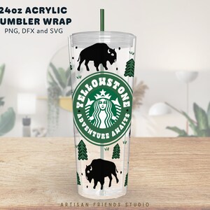 May include: A 24 ounce clear acrylic tumbler with a design featuring a black silhouette of a bison, green pine trees, and a green circle with the text "Yellowstone Adventure Awaits" and a stylized image of a mermaid with a crown.