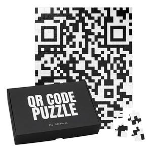 May include: A black and white jigsaw puzzle featuring a QR code pattern. The puzzle is accompanied by a black rectangular box with the white text QR CODE PUZZLE and 110 / 520 PIECES printed on the front, along with three loose puzzle pieces.