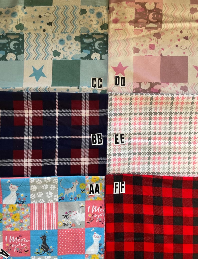May include: A collection of six fabric swatches labeled CC, DD, BB, EE, AA, and FF. Patterns include blue celestial motifs, pink celestial designs, navy and red plaid, pink and white houndstooth, cat-themed floral prints, and red and black buffalo check.