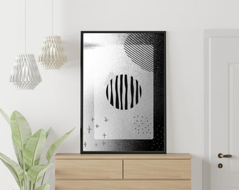 May include: Black and white abstract art print with a striped circle, geometric shapes, and a textured background. The print is framed in a black frame and hanging on a white wall.