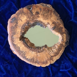Mirror enclosed in Manzanita Burl Wood, sanded and polished