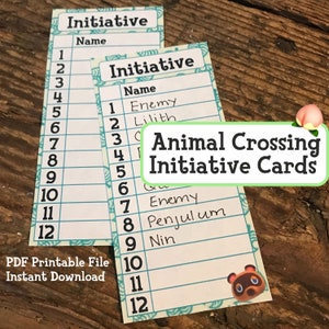 May include: Two printable Animal Crossing initiative cards with a numbered list from 1 to 12. The cards are white with a blue and green border. The text "Animal Crossing Initiative Cards" is written in green on a peach background. The cards are on a wooden surface.