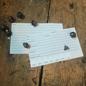 May include: A character sheet for a role-playing game with dice scattered around it. The sheet has sections for name, race, appearance, characteristics, backstory, roleplay notes, alignment, languages, and stats. The dice are black with gold numbers.